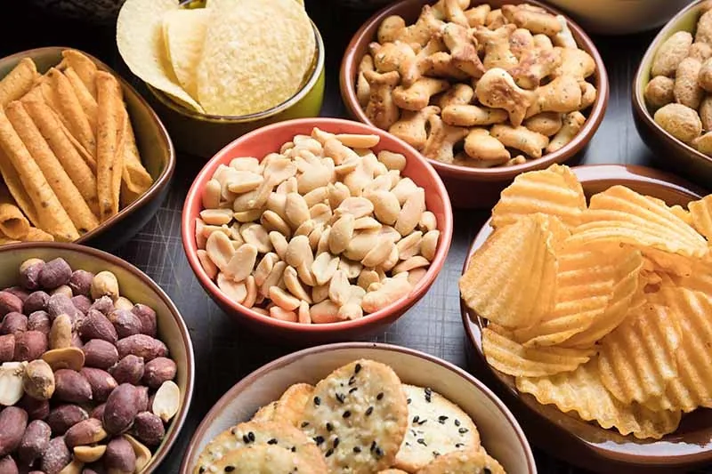 Assorted crunchy savoury snacks and chip packs