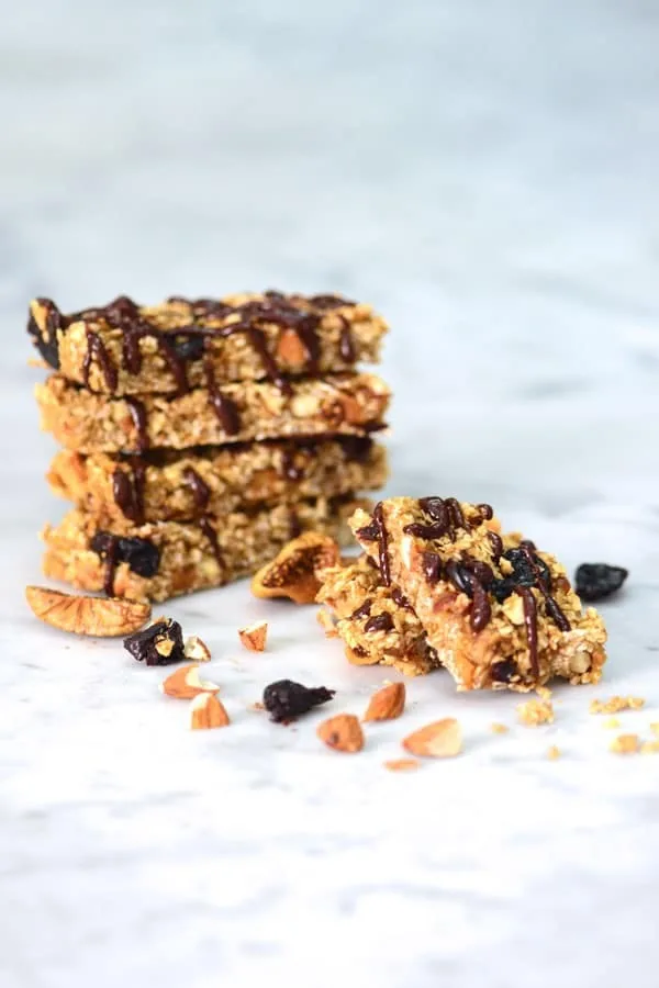 Chocolate drizzled granola bars with nuts and berries